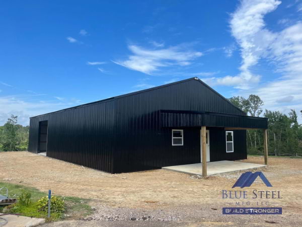 black metal barndominium with a small covered front area