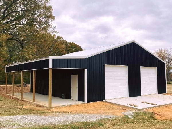 black garage with white doors and roof covered side