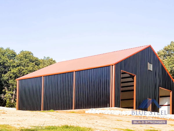 Black siding garage with orange triming, gutters and roof