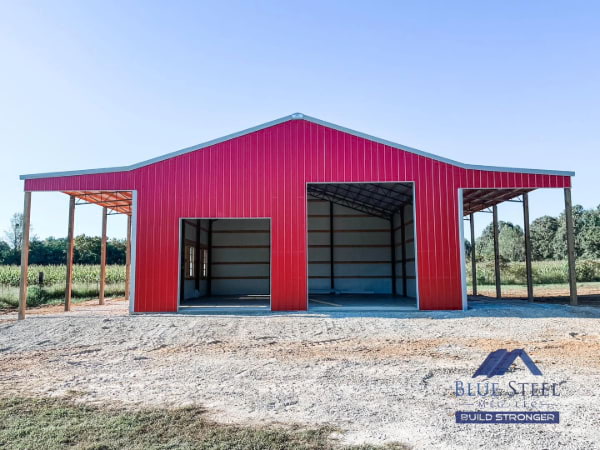 bright red garage with two different door sizes on front, with covered side areas