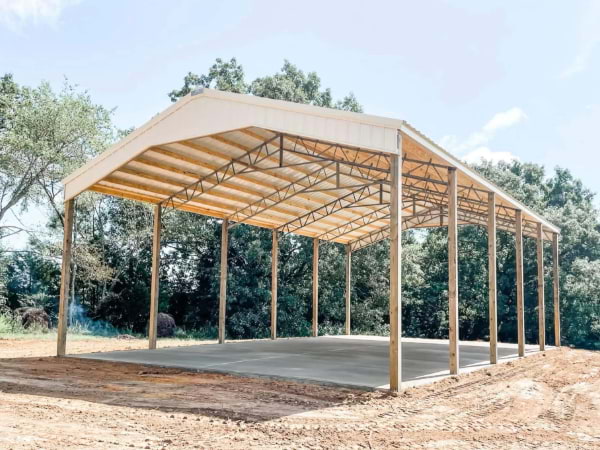 Post frame garage with tan metal roof and accents