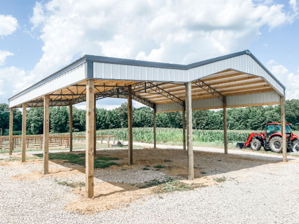 Post frame garage with a gray roof and white accents