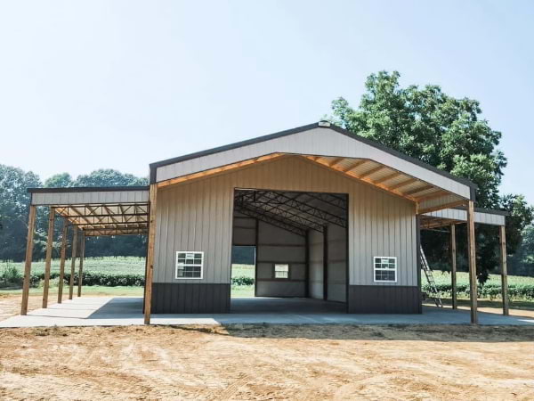 multi color tan shop with a large door to pull in through and covered side areas