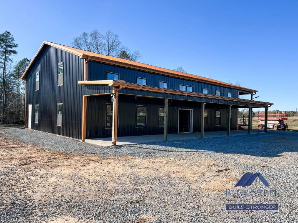 black metal barndominium with a covered porch