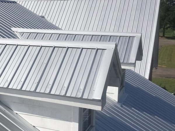 Light grey metal roofing over different arches