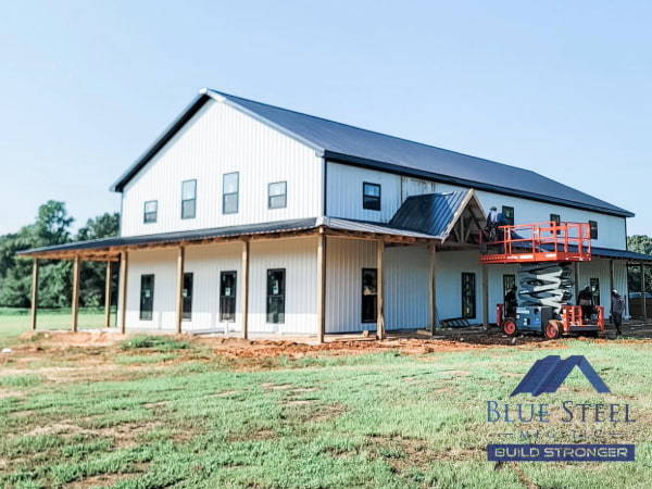 white barndominium with black roof
